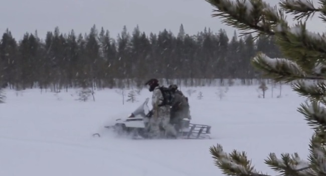 10th Special Forces Group Soldiers riding a snowmobile during Winter Warfare training. (Photo from video by SSG William Reinier, 10th SFGA, Oct 25, 2017).