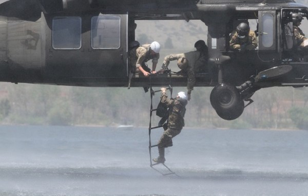 Soldier from 10th Special Forces Group climbs a ladder during water extraction on Chatfield Reservoir near Littleton, Colorado. Photo by SSG Brandon McIntosh, 10th SFGA, Sep 3, 2012.