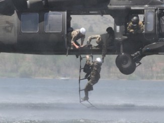 Soldier from 10th Special Forces Group climbs a ladder during water extraction on Chatfield Reservoir near Littleton, Colorado. Photo by SSG Brandon McIntosh, 10th SFGA, Sep 3, 2012.