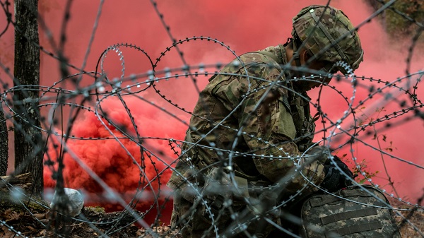 A combat medic assigned to the 82nd Airborne Division, Fort Bragg, N.C., readies his equipment before embarking on his final evaluation lane while competing for the Expert Field Medical Badge Nov. 6, 2018, at Fort Bragg, N.C. The first week of testing introduces the candidates to all the tasks that they’ll be expected to complete to earn the coveted badge. The EFMB was established to showcase and recognize medical Soldiers for their exceptional skill level and competence in the medical field. The testing consists of a written exam, land navigation, three separate combat testing lanes and concludes with a 12-mile ruck march. (U.S. Army photo by Sgt. Dustin Biven / 22nd Mobile Public Affairs Detachment)