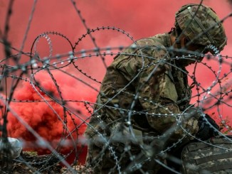 A combat medic assigned to the 82nd Airborne Division, Fort Bragg, N.C., readies his equipment before embarking on his final evaluation lane while competing for the Expert Field Medical Badge Nov. 6, 2018, at Fort Bragg, N.C. The first week of testing introduces the candidates to all the tasks that they’ll be expected to complete to earn the coveted badge. The EFMB was established to showcase and recognize medical Soldiers for their exceptional skill level and competence in the medical field. The testing consists of a written exam, land navigation, three separate combat testing lanes and concludes with a 12-mile ruck march. (U.S. Army photo by Sgt. Dustin Biven / 22nd Mobile Public Affairs Detachment)