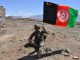 Afghan Soldier holds Afghan flag.