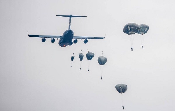 Paratroopers descend from a US Air Force cargo transport. (Photo USAF December 1, 2017).