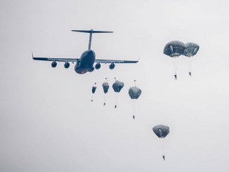 Paratroopers descend from a US Air Force cargo transport. (Photo USAF December 1, 2017).