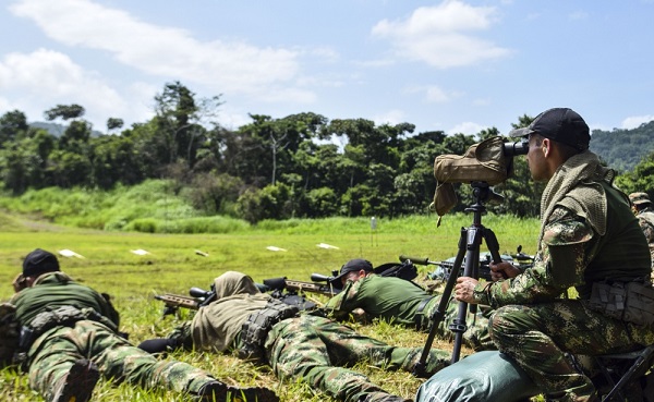 A Colombian competitor uses his Data of Previous Engagement (DOPE) during the zeroing of weapons for this year's Fuerzas Comando, July 15, 2018 on a shooting range in Panama City, Panama. Fuerzas Comando is an annual multinational special operational forces skills competition sponsored by U.S. Southern Command and hosted this year by the Ministry of Public Security, Panama. Through friendly competition, this exercise promotes interoperability, military-to-military relationships, increases training knowledge, and improves regional security. (U.S. Army Photo by Staff Sgt. Brian Ragin/Released)