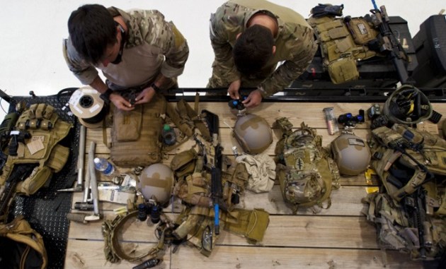 Special Forces Green Berets prepare their weapons and gear prior to a training event. (photo by Tech Sgt Jorge Intriago, South Carolina National Guard, May 19, 2014).