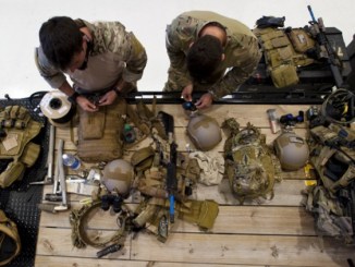 Special Forces Green Berets prepare their weapons and gear prior to a training event. (photo by Tech Sgt Jorge Intriago, South Carolina National Guard, May 19, 2014).