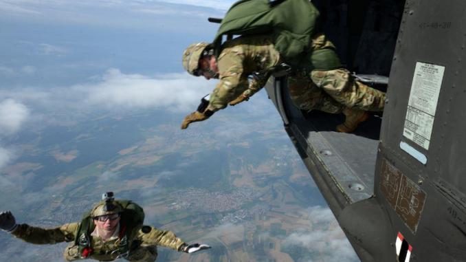 Personnel from Special Operations Command Europe (SOCEUR) perform a high altitude low opening (HALO) parachute jump from a U.S. Army Sikorsky UH-60 Black Hawk helicopter at 12,000 feet in Stuttgart, Germany. (U.S. Army photo by SPC Jason Johnston, 18 Aug 2016).