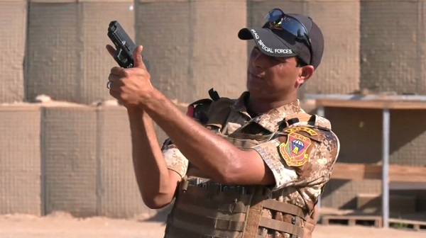 A Iraqi Counter-Terrorism Service instructor shows the correct way to hold and aim a 9mm pistol. Photo from video by CJTF-OIR, SGT Rodney Roldan, August 1, 2018.