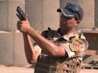 A Iraqi Counter-Terrorism Service instructor shows the correct way to hold and aim a 9mm pistol. Photo from video by CJTF-OIR, SGT Rodney Roldan, August 1, 2018.