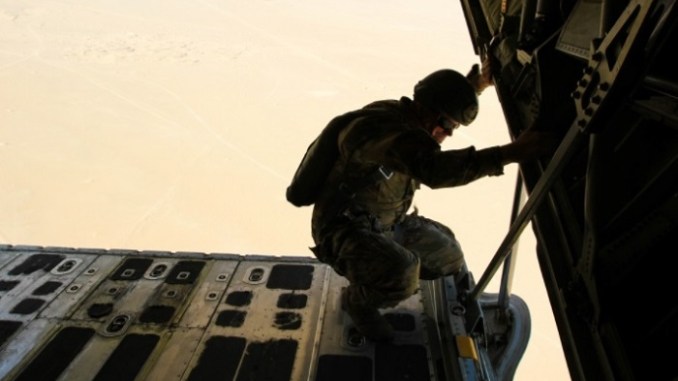 AMP BUEHRING, Kuwait (Oct. 17, 2017) – SFC Jonathan Newell, headquarters NCOIC for the 7th SFG, monitors jumpers during their descent. The air mission was a recertification jump monitored by members of the SOJTF and 1st TSC. (U.S. Army photo by Capt. Jacqueline Whitt)