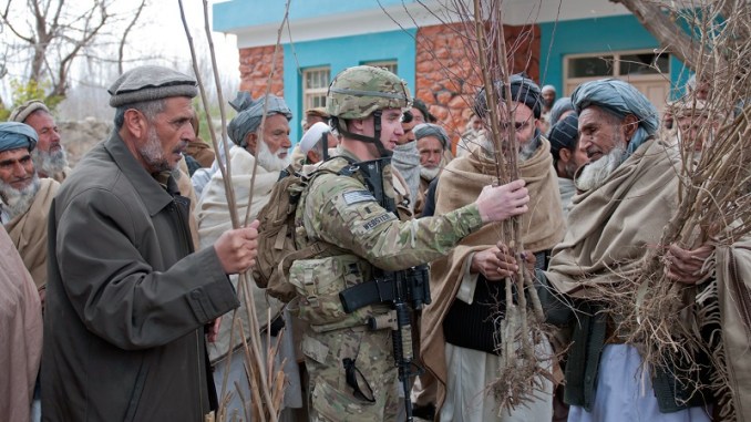 A member of an Agricultural Development Team (ADT) talks with an Afghan villager about crops. (Photo U.S. Army SPC Leslie Goble, 2012). Jeff Goodson article on development in conflict areas.