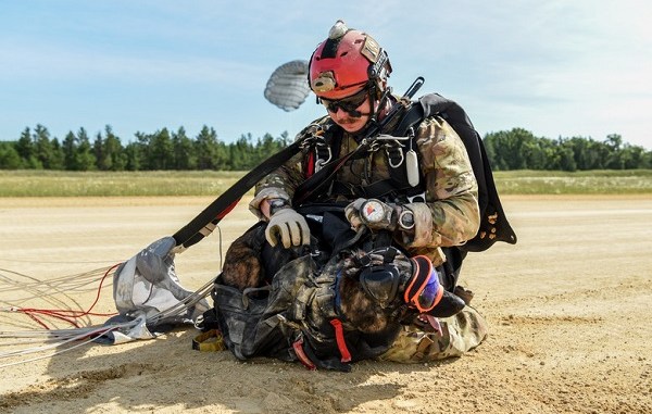 Master Sgt. Rudy Parsons, pararescueman for the 123rd Special Tactics Squadron, and Callie, his search and rescue K-9, land at Fort McCoy, Wis. July 17, 2019, as part of an domestic operations exercise. Callie is currently the only search and rescue dog in the Department of Defense. (U.S. Air National Guard photo by Staff Sgt. Joshua Horton)