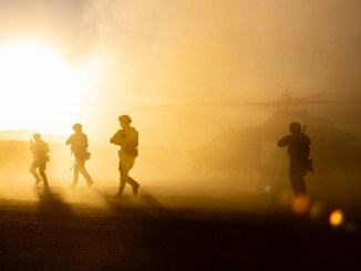 Marine Raiders disembark from helicopter during vehicle interdiction mission.