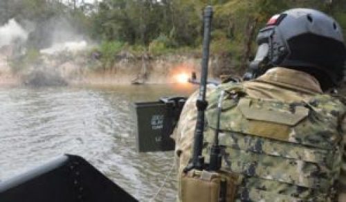 NAVSCIATTS PCAT student fires weapon during scenario driven field training exercise. (Photo from NAVSCIATT Guide Book, April 2017).