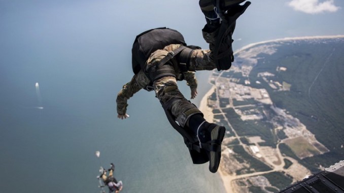 Sailors exit a Chinook during HALO parachute jump. (DoD photo July 20, 2017).