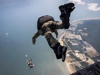 Sailors exit a Chinook during HALO parachute jump. (DoD photo July 20, 2017).