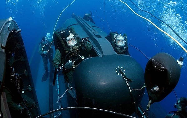 SEALs prepare to launch Swimmer Delivery Vehicle (SDV) from the back of the USS Philadelphia. The SDVs are used to carry Navy SEALs from a submerged submarine to enemy targets while staying underwater and undetected. U.S. Navy photo by Chief Photographer's Mate Andrew McKaskle, May 5, 2005.