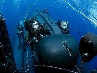 SEALs prepare to launch Swimmer Delivery Vehicle (SDV) from the back of the USS Philadelphia. The SDVs are used to carry Navy SEALs from a submerged submarine to enemy targets while staying underwater and undetected. U.S. Navy photo by Chief Photographer's Mate Andrew McKaskle, May 5, 2005.