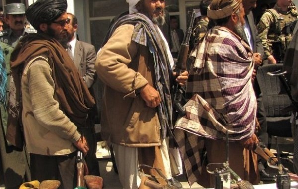 Former Taliban turn in their weapons during an APRP ceremony in Ghor province, Afghanistan on May 28, 2012. Photo by Lt JG Joe Painter, DoD.