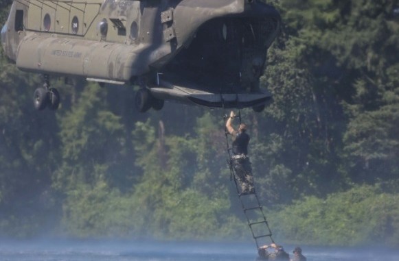 1st SFGA Soldier ascends a ladder to board helicopter while conducting water operations training. (Photo by SGT Codie Mendenhall, July 25, 2017).