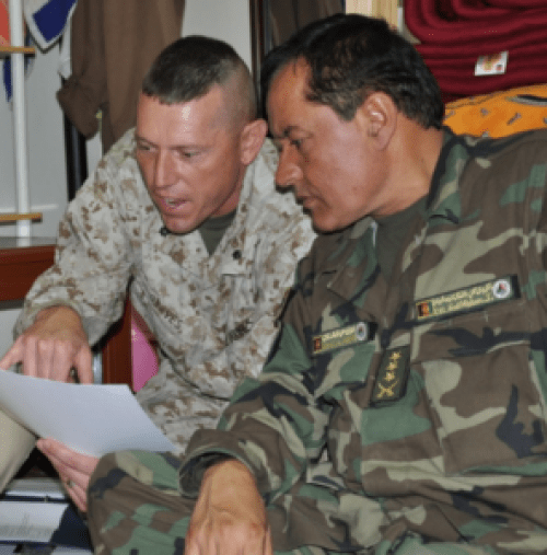 USMC Lt. Col. David Graves, a logistics advisor with the AAC-SW, interacts with an Afghan counterpart at ANA 215th Corps. (Photo by LT. Sharon Mulholland, DoD)