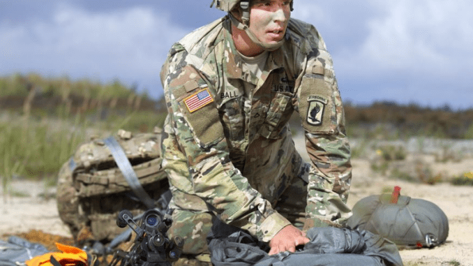 Parachutist gathers his parachute after airborne operation. (Photo by PFC James Dutkavich, Sep 12, 2016)