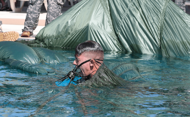 A member of 1/1st Special Forces Group swims out from underneath his parachute canopy in a pool in as part of water jump training. (photo Richard Rzepka - USAG Okinawa).